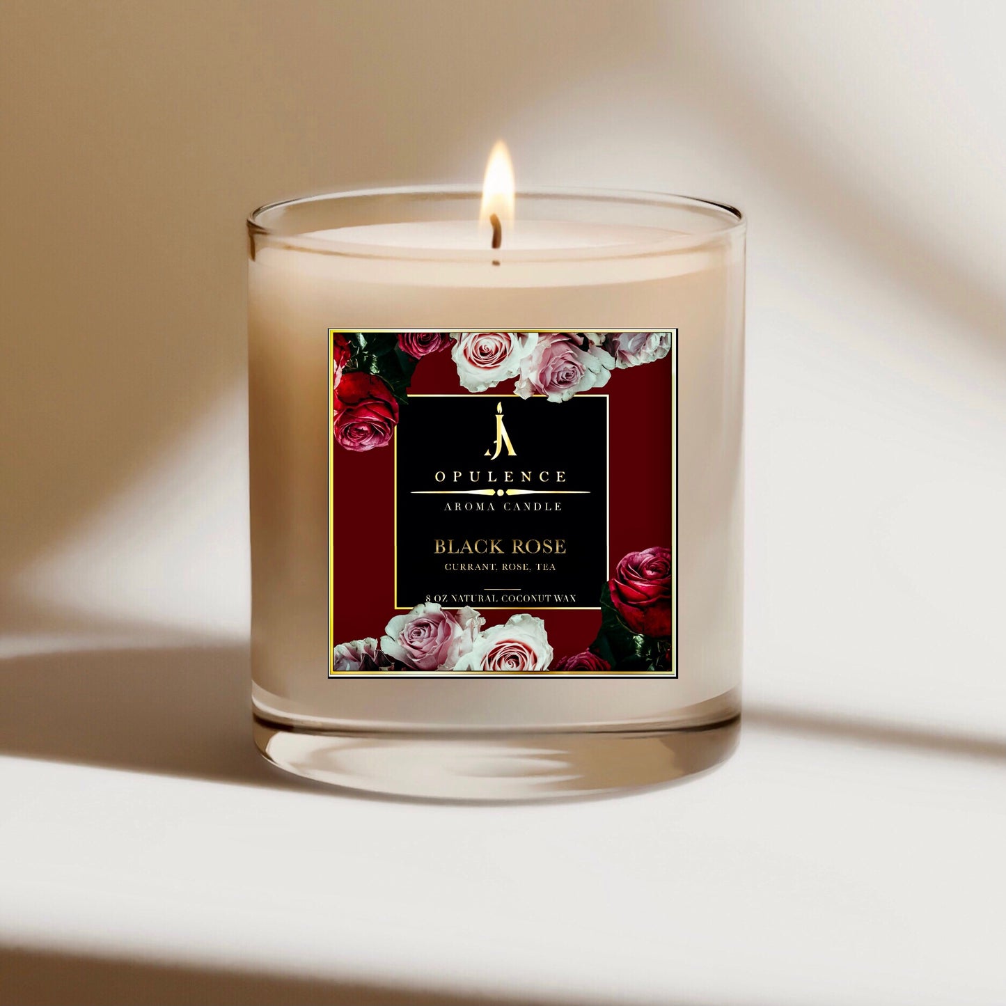Rose scented candle with coconut wax and floral design on the jar with black lid, sitting on a white surface