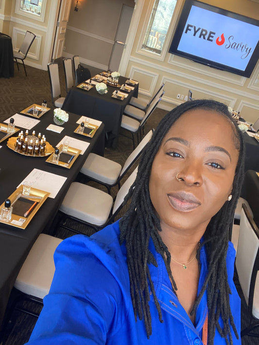 Tye is wearing blue at a business retreat where she is sharing her workshop experience.