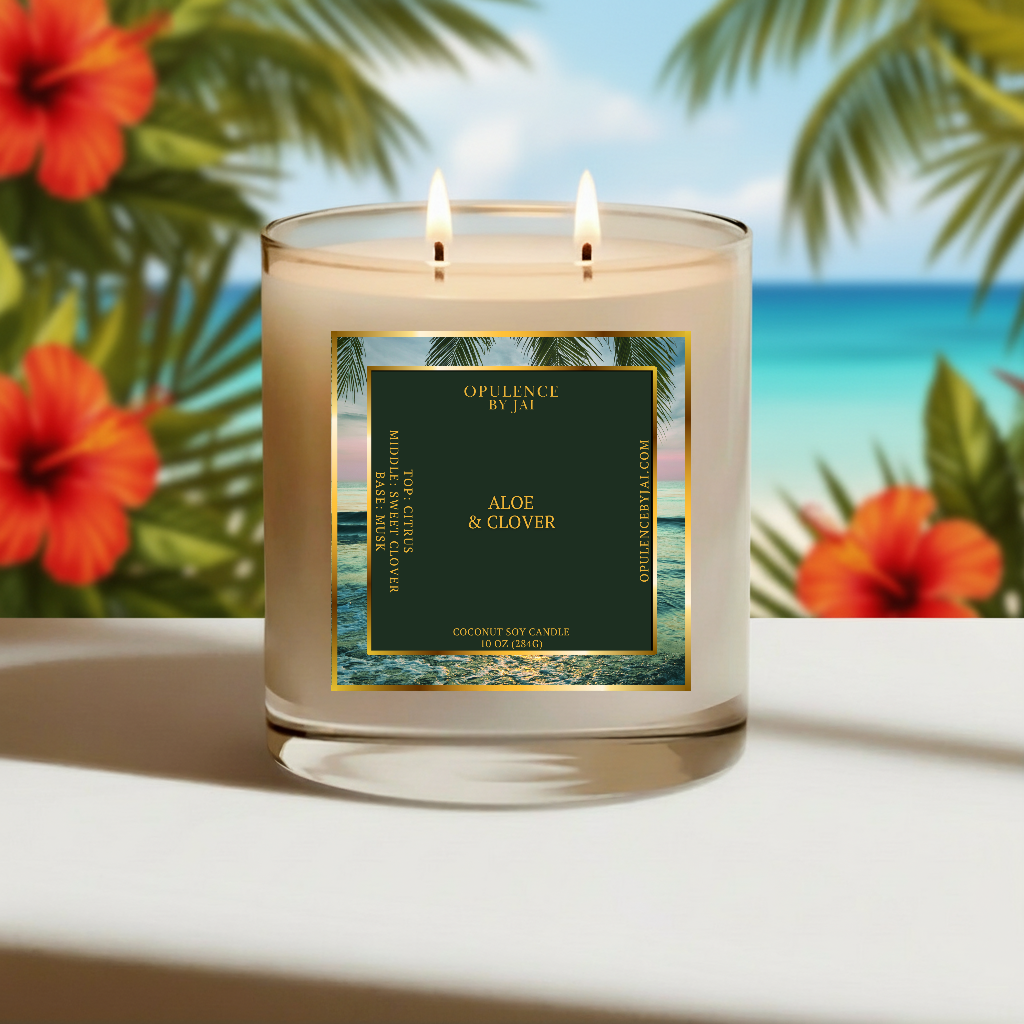 Candle with a label in front of tropical flowers and ocean view